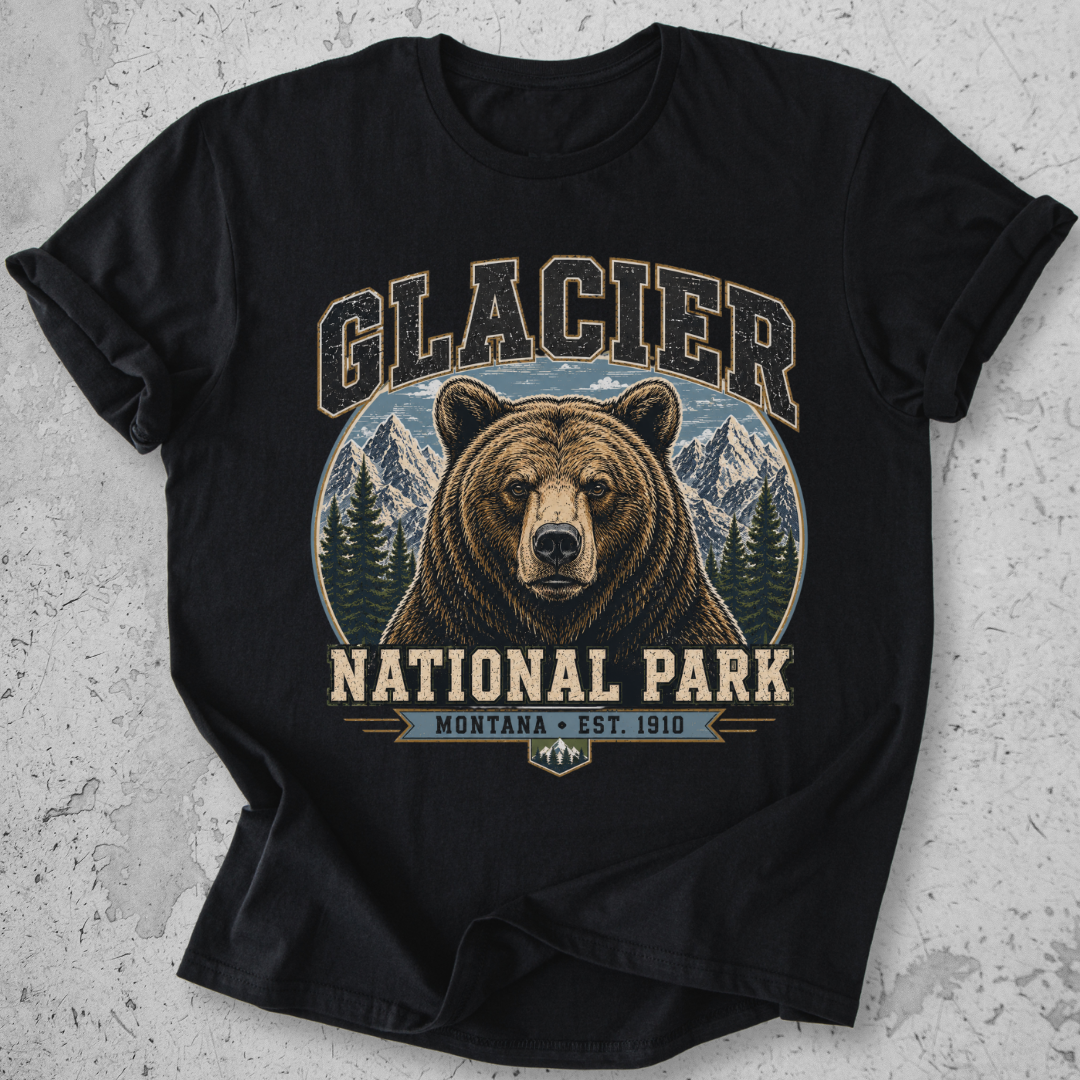 A black short-sleeve t-shirt with a vintage-style graphic of a grizzly bear in Glacier National Park, Montana